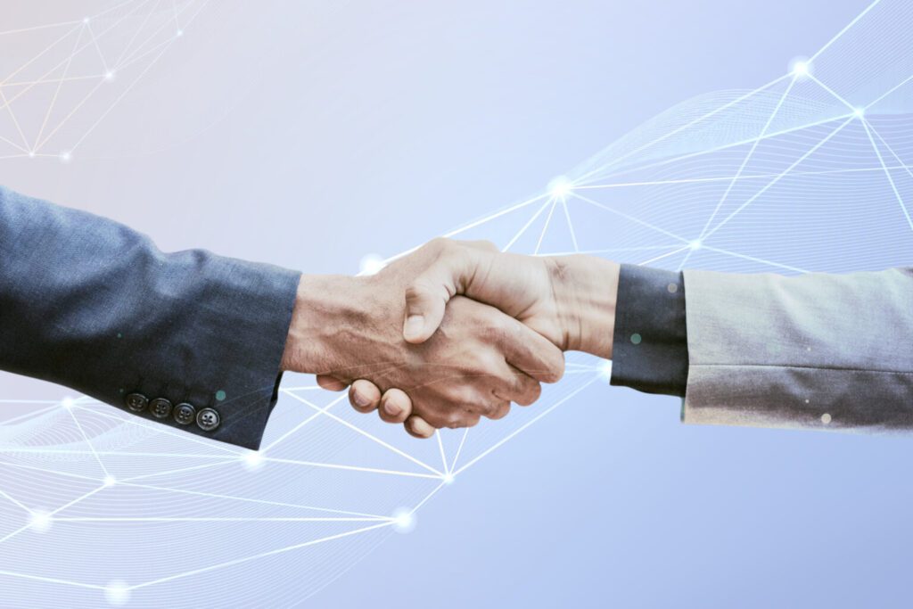Aperto de mãos com rede digital ao fundo, simbolizando a cooperação entre Brasil e Argentina em ciência e tecnologia.