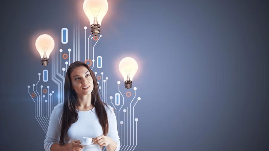 Mulher observando lâmpadas acesas com circuitos ao fundo, simbolizando investimento da Finep e do MCTI de R$ 240 milhões em 19 parques tecnológicos no Brasil.