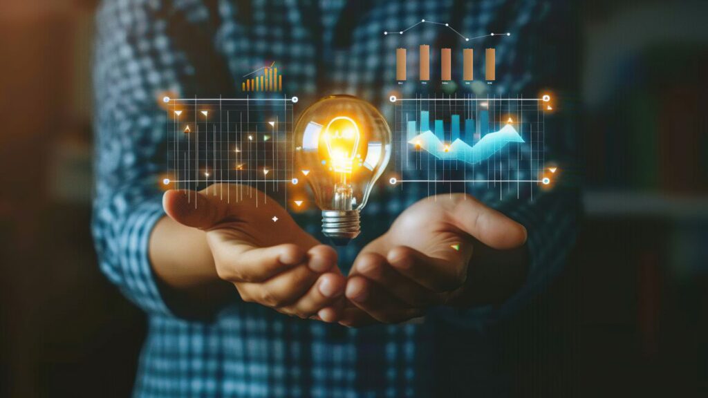 Mãos segurando lâmpada com gráficos digitais — MCTI anuncia investimento de R$ 1,5 bilhão em empresas inovadoras do Rio Grande do Sul.