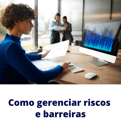 Analista monitora gráficos em tela e relatório impresso para gerenciar riscos e barreiras.